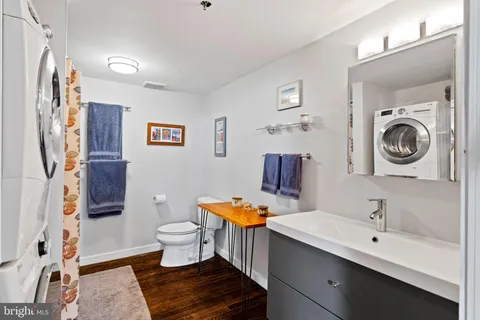 a bathroom with a toilet a sink and a mirror