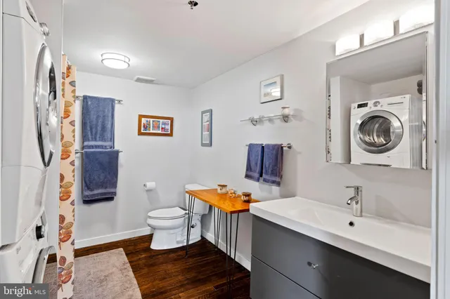 a bathroom with a toilet a sink and a mirror