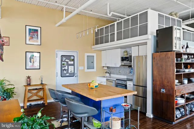a view of a dining room with furniture a rug and wooden floor