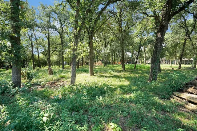an aerial view of a house with a yard and garden