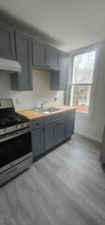 a kitchen with stainless steel appliances granite countertop a stove and a sink