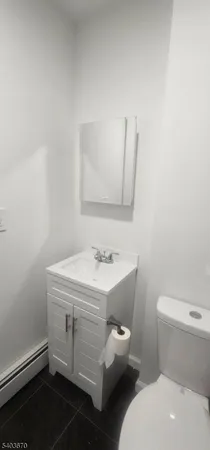 a bathroom with a sink toilet and mirror
