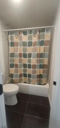 a bathroom with a bathtub and a toilet