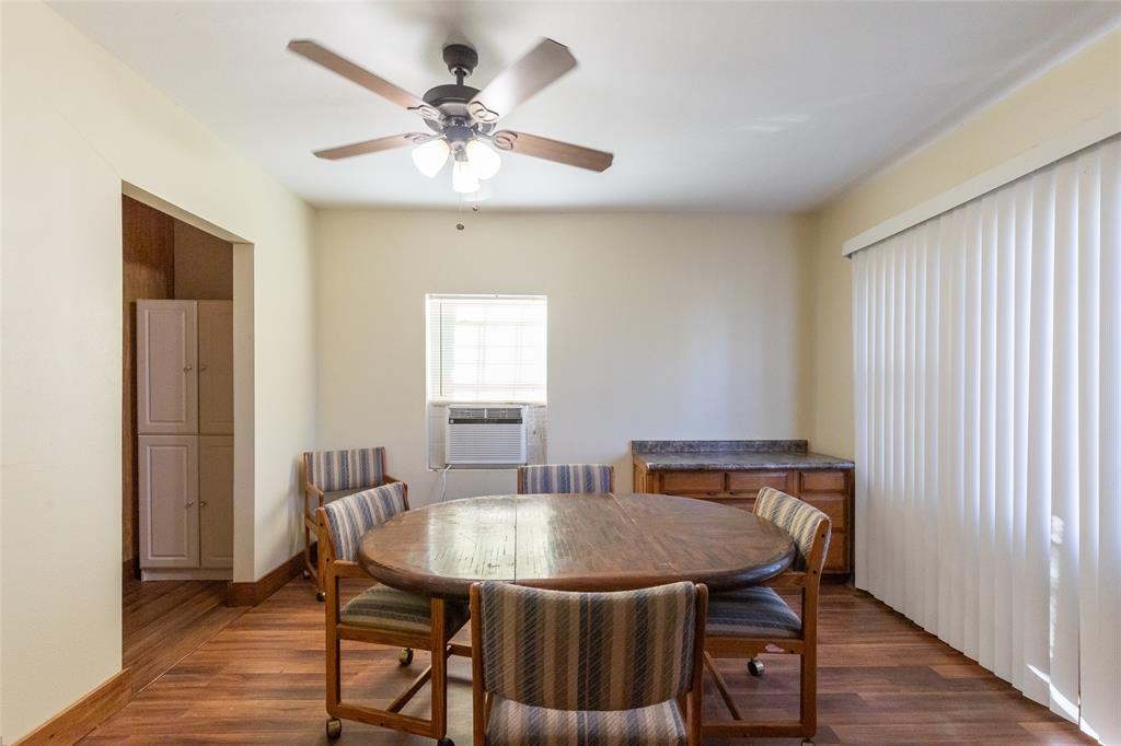 640 Ground Street Moran, TX 76464 - Photo 12 of 35 Spacious room featuring wood-finish flooring, a ceiling fan with integrated lighting, and neutral wall tones