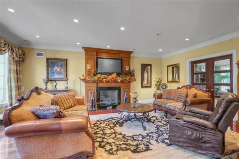 a living room with furniture a large window and a fireplace
