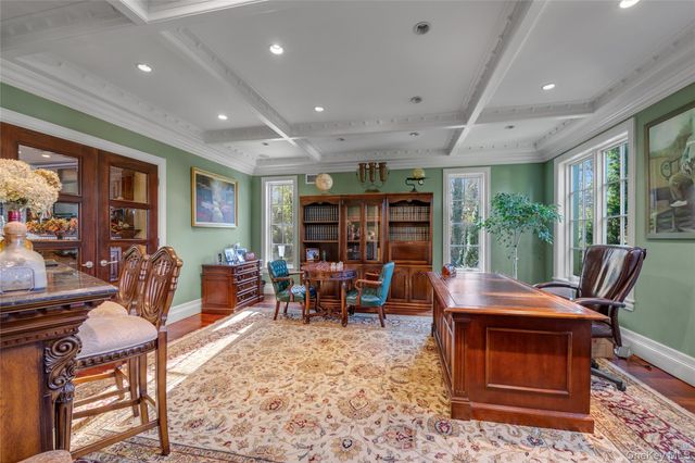 a living room with furniture a rug and a floor to ceiling window