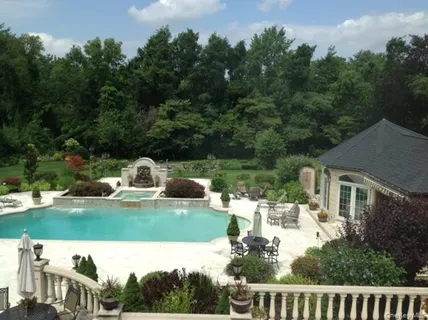 a view of a house with backyard sitting area and lake view