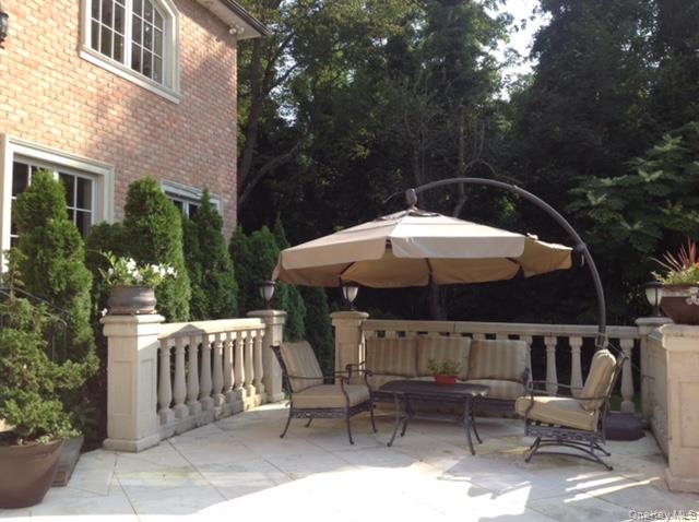 109 Wheatley Road Glen Head, NY 11545 - Photo 39 of 47 a backyard of a house with table and chairs