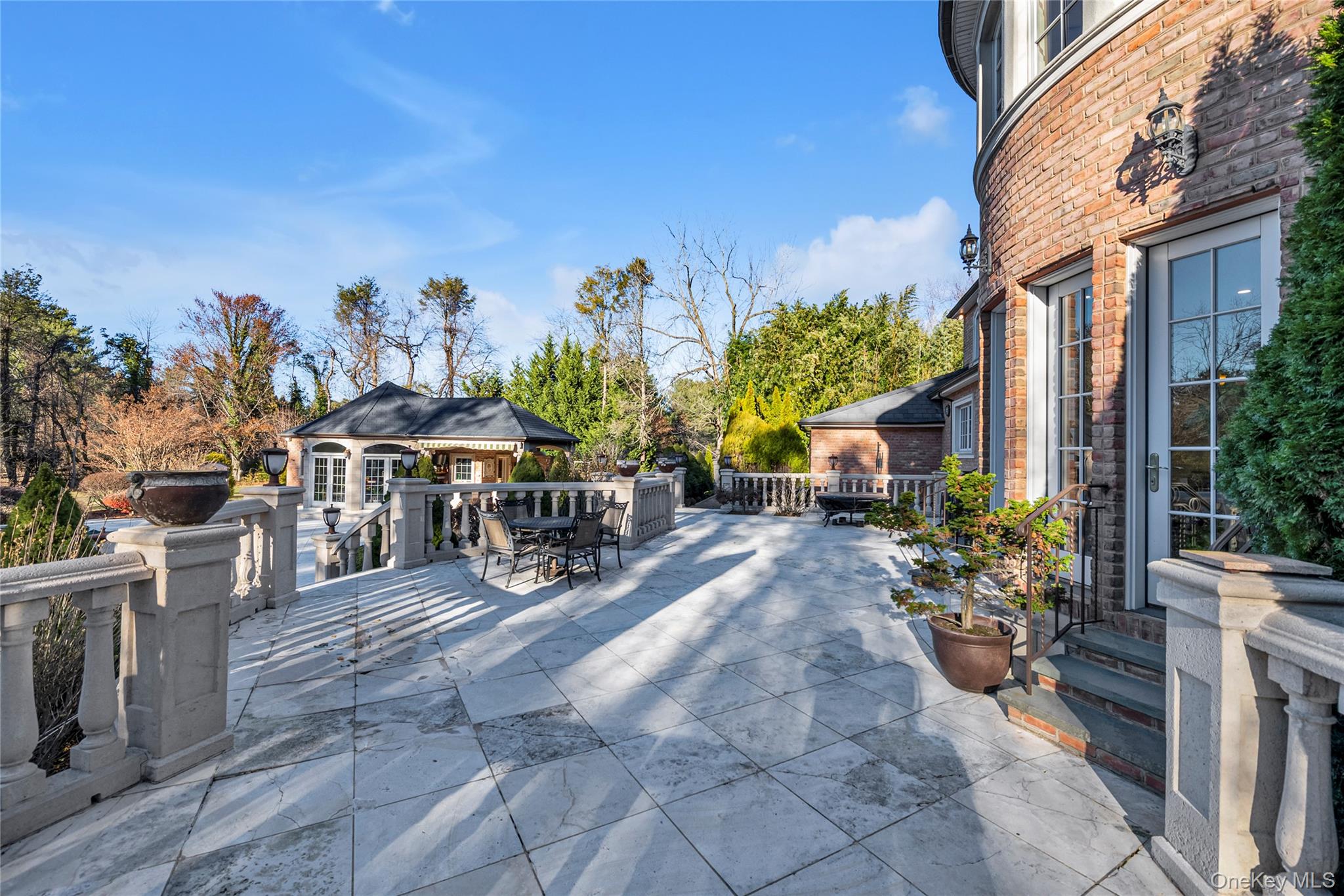 109 Wheatley Road Glen Head, NY 11545 - Photo 45 of 47 a view of a patio with table and chairs potted plants with sky view