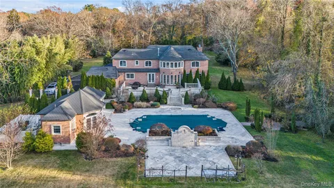 an aerial view of a house with yard swimming pool and outdoor seating
