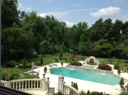 a view of a wooden deck and a yard