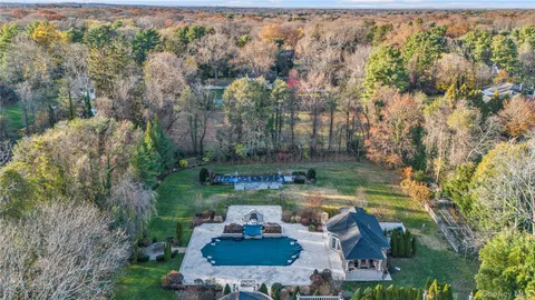 an aerial view of a house with swimming pool outdoor seating and yard