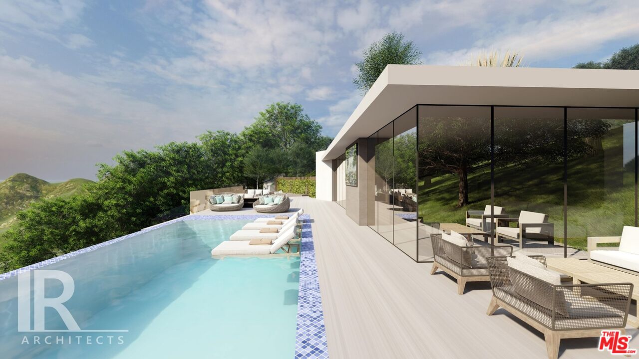 6041 Kanan Dume Road Malibu, CA 90265 - Photo 5 of 6 a view of a patio with couches table and chairs and potted plants