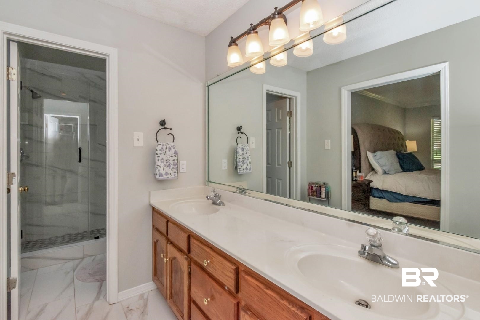 9991 Wedgefield Court Mobile, AL 36608 - Photo 16 of 30 Bathroom with dual vanity, a shower with door, and tile patterned floors
