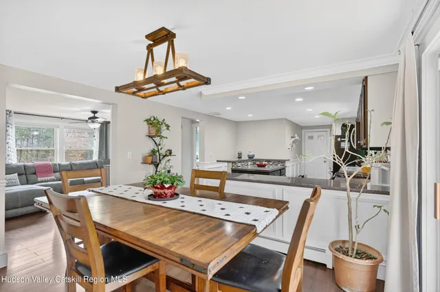 a living room with furniture a rug and white walls