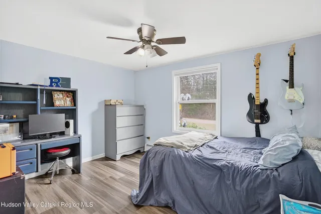 a bedroom that has a bed and a book shelf
