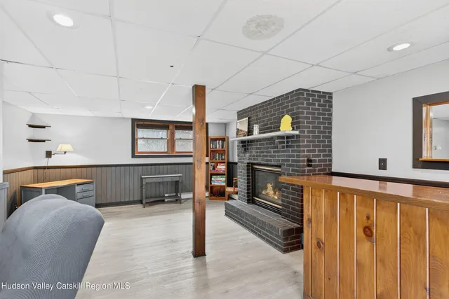 a living room with furniture a fireplace and a table