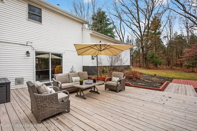 a view of a patio with couches and umbrella
