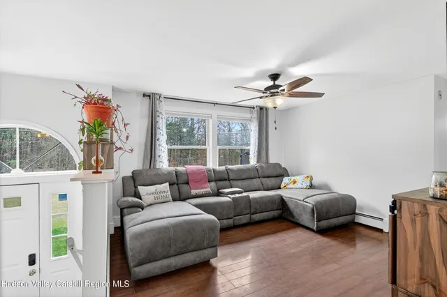 a living room with furniture and a large window