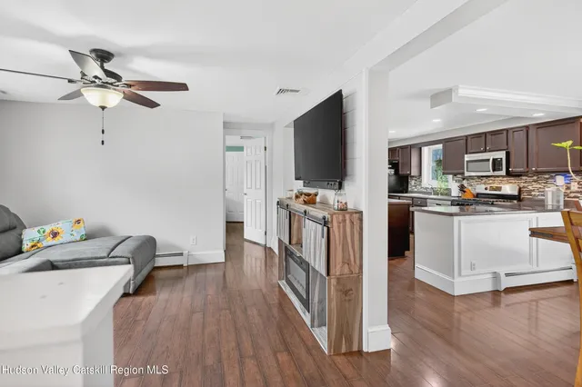 a kitchen with kitchen island white cabinets and stainless steel appliances