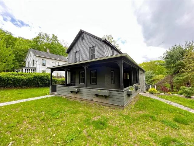 a view of a house with a yard patio and sitting area