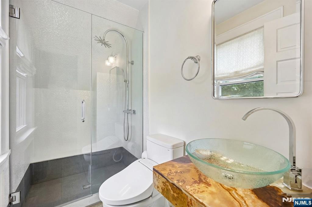 57 Oldis Street Rochelle Park, NJ 07662 - Photo 11 of 19 a bathroom with a granite countertop toilet sink and mirror