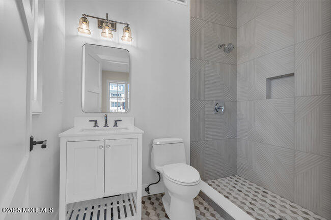 11 Union Avenue Spring Lake, NJ 07762 - Photo 27 of 109 a bathroom with a toilet a sink a shower and a mirror