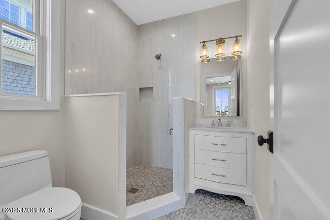 11 Union Avenue Spring Lake, NJ 07762 - Photo 47 of 109 a bathroom with a sink a toilet a mirror and shower