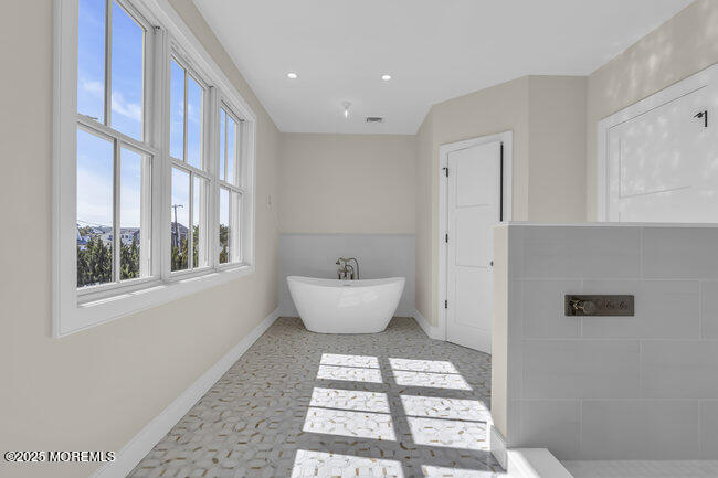 11 Union Avenue Spring Lake, NJ 07762 - Photo 58 of 109 a bathroom with a white bath tub and a window