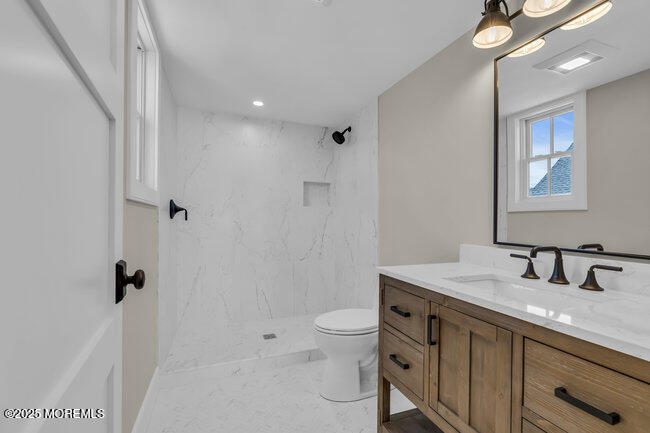 11 Union Avenue Spring Lake, NJ 07762 - Photo 66 of 109 a bathroom with a sink a toilet a shower and a mirror
