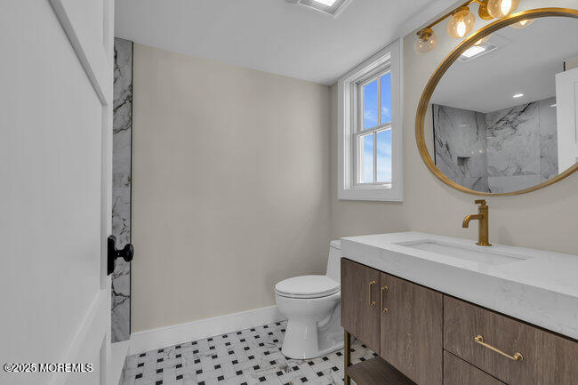 11 Union Avenue Spring Lake, NJ 07762 - Photo 72 of 109 a bathroom with a sink a toilet and a mirror