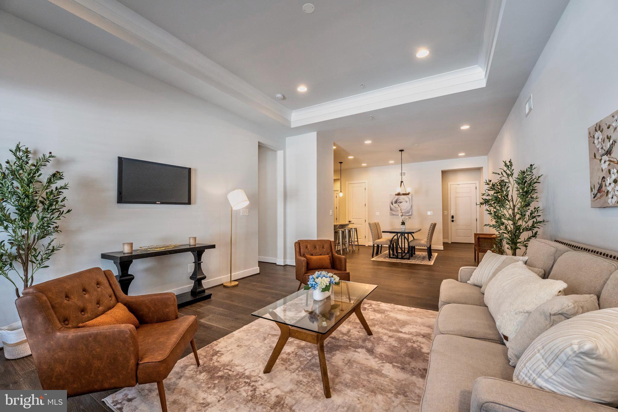 23716 September Sun Square Ashburn, VA 20148 - Photo 15 of 48 a living room with furniture and a flat screen tv