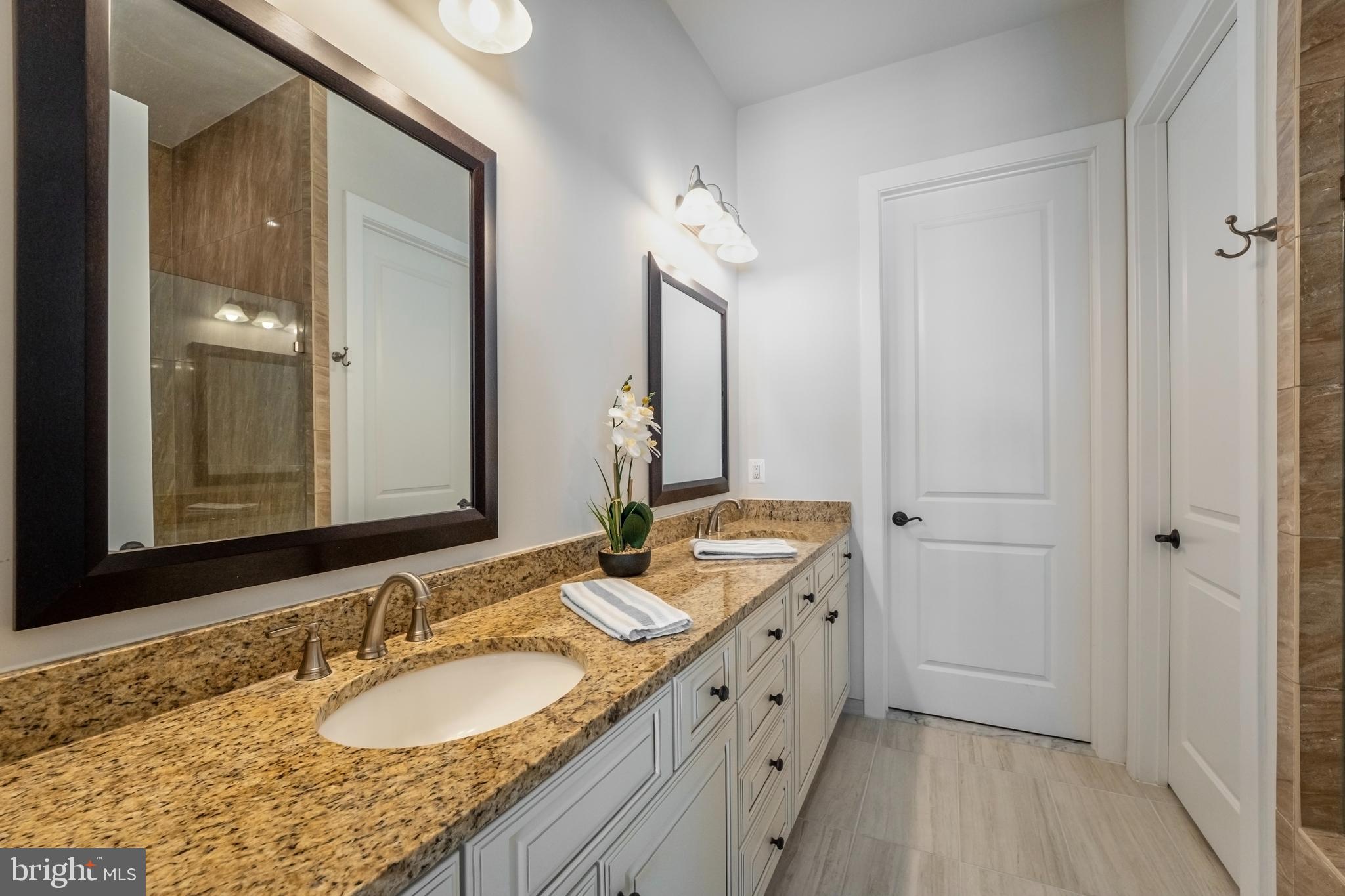 23716 September Sun Square Ashburn, VA 20148 - Photo 20 of 48 a bathroom with a granite countertop double vanity sink and a mirror