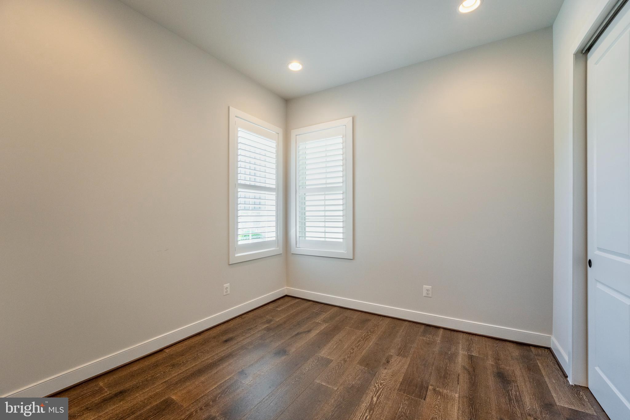 23716 September Sun Square Ashburn, VA 20148 - Photo 23 of 48 an empty room with wooden floor and windows