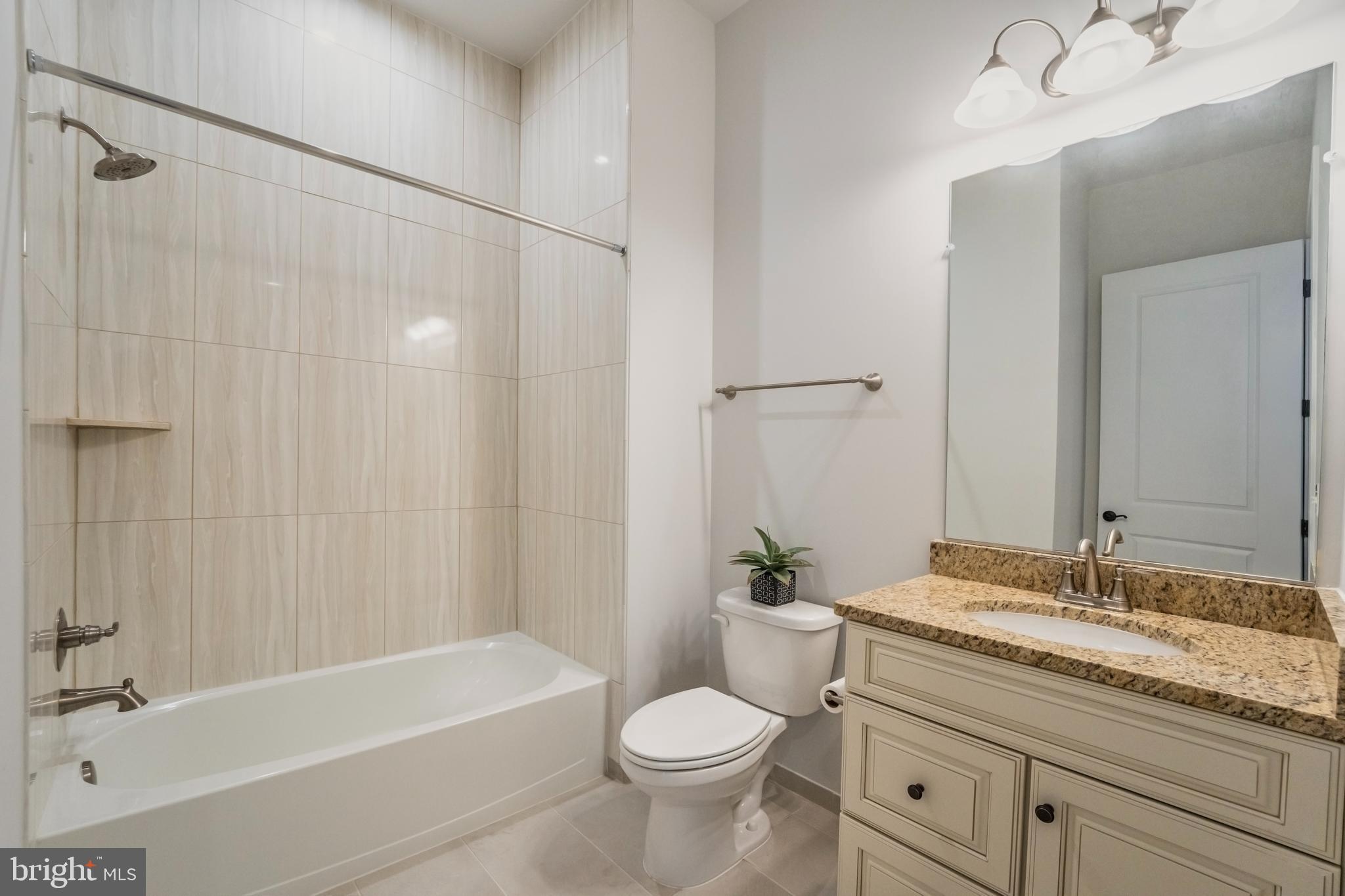 23716 September Sun Square Ashburn, VA 20148 - Photo 24 of 48 a bathroom with a granite countertop sink a toilet and shower