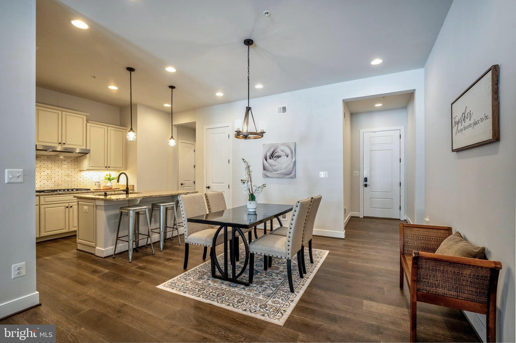 23716 September Sun Square Ashburn, VA 20148 - Photo 5 of 48 a view of a dining room with furniture and wooden floor