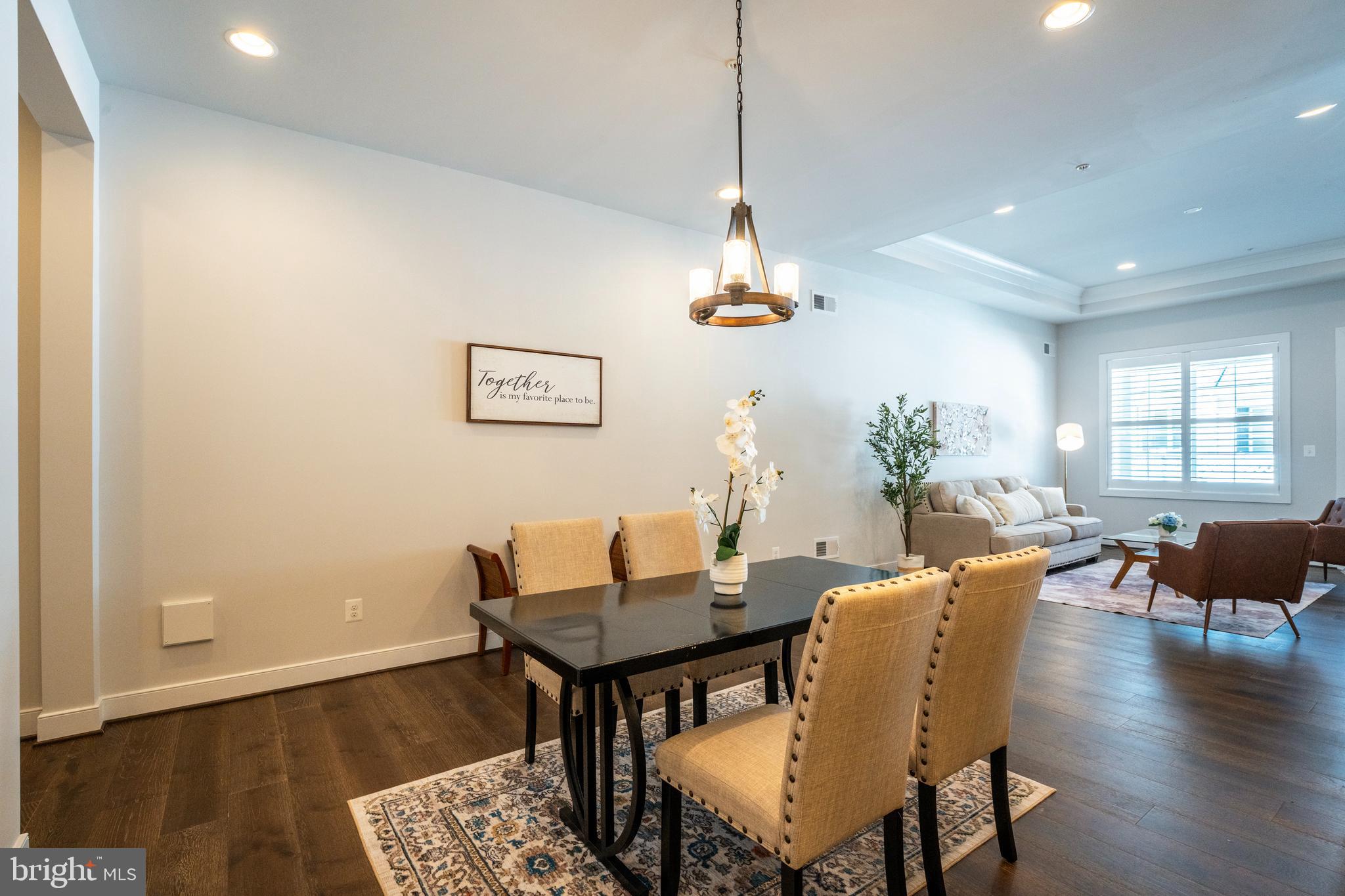 23716 September Sun Square Ashburn, VA 20148 - Photo 7 of 48 a view of a dining room with furniture window and wooden floor
