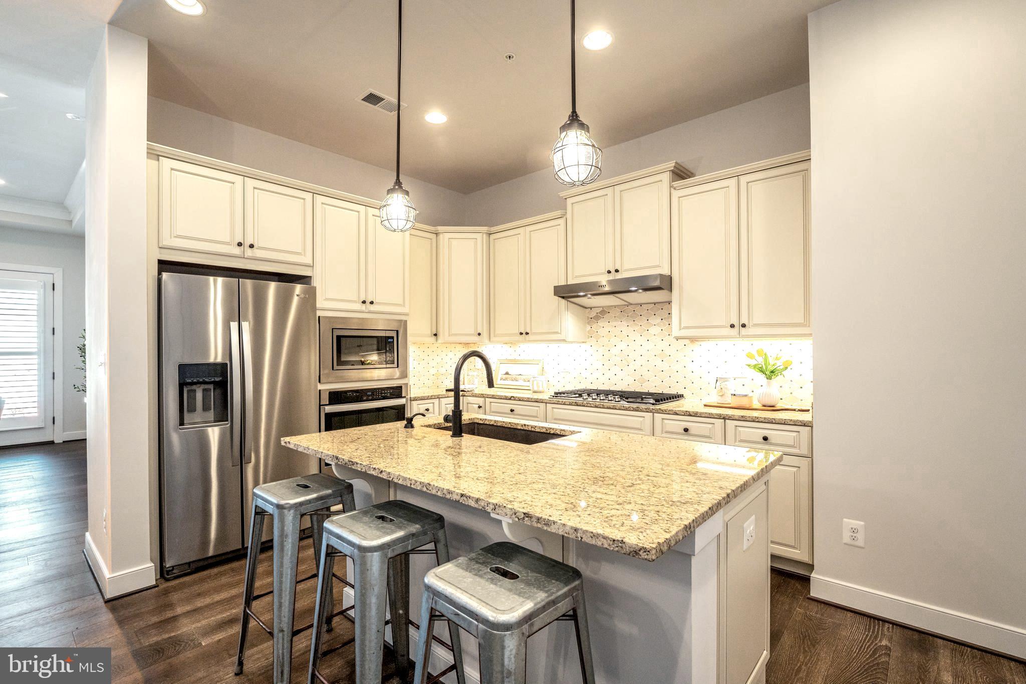 23716 September Sun Square Ashburn, VA 20148 - Photo 9 of 48 a kitchen with a refrigerator a stove a sink and a refrigerator