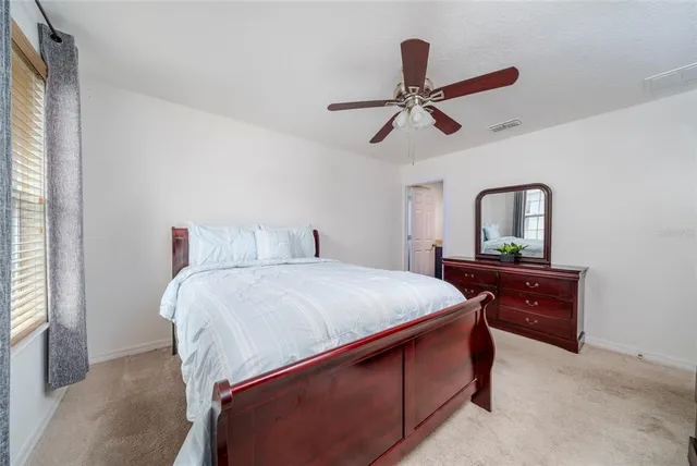 a bedroom with a bed and a dresser