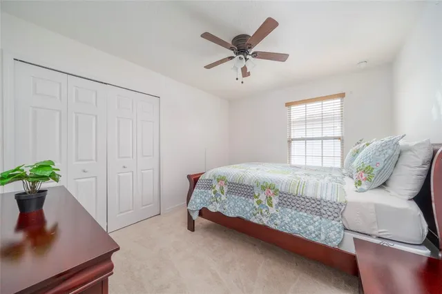 a bedroom with a bed and a potted plant