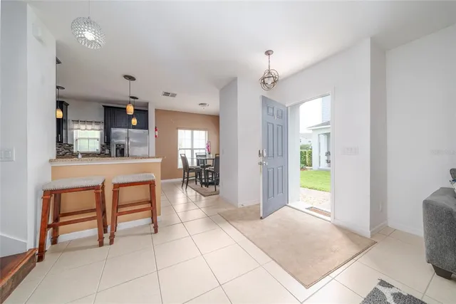 a view of kitchen with sink and refrigerator