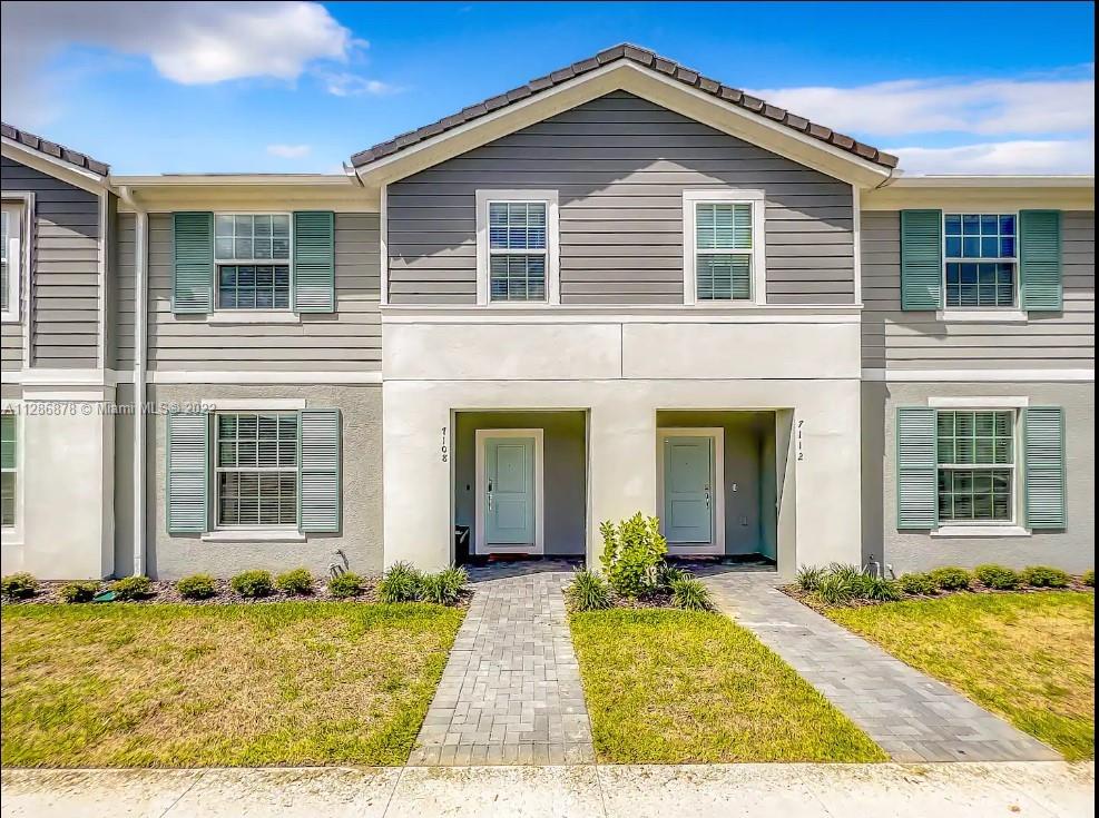 a front view of a house with a yard