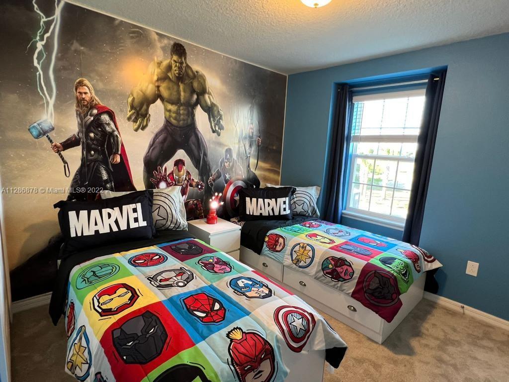 7108 Oakmoss Loop Davenport, FL 33837 - Photo 14 of 20 a bedroom with two beds and a painting on the wall