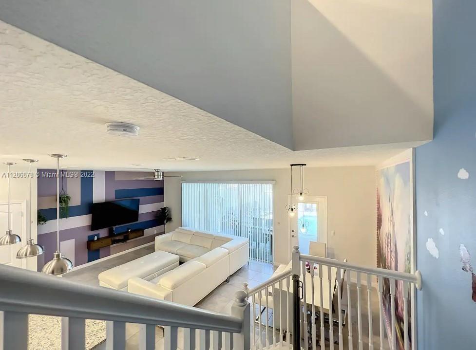 7108 Oakmoss Loop Davenport, FL 33837 - Photo 3 of 20 a living room with furniture and a flat screen tv