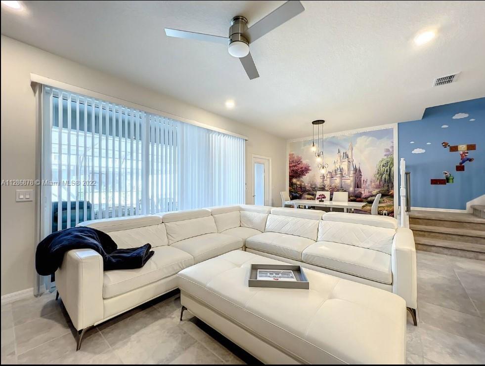 7108 Oakmoss Loop Davenport, FL 33837 - Photo 5 of 20 a living room with furniture and a large window