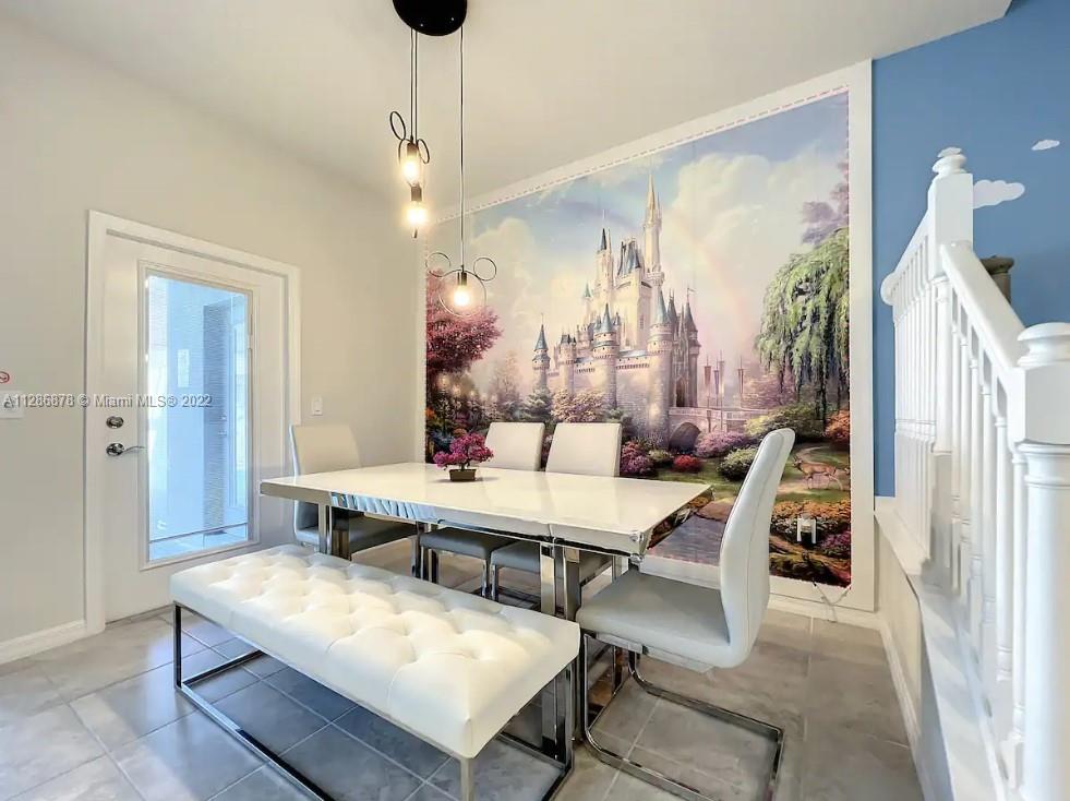 7108 Oakmoss Loop Davenport, FL 33837 - Photo 6 of 20 a view of a dining room with furniture and a chandelier