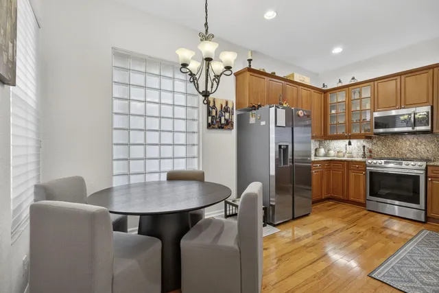 a kitchen with stainless steel appliances granite countertop a sink stove and microwave