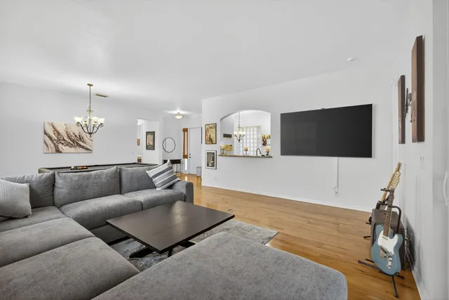 a bedroom with a bed and a chandelier