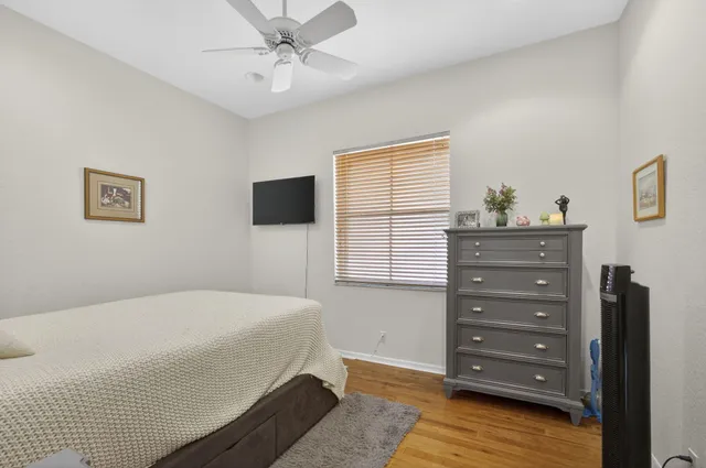 a bedroom with a bed chair and a window