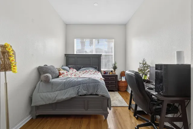 a bedroom with a bed and a flat screen tv
